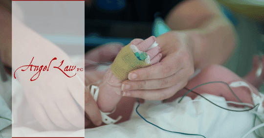 Person checking infant's foot for injury