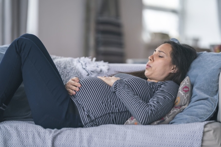 pregnant women on couch having painful contractions