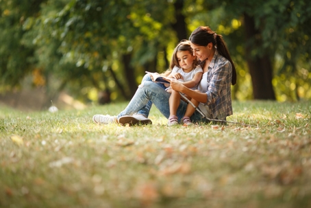 mother and daughter sitting in park