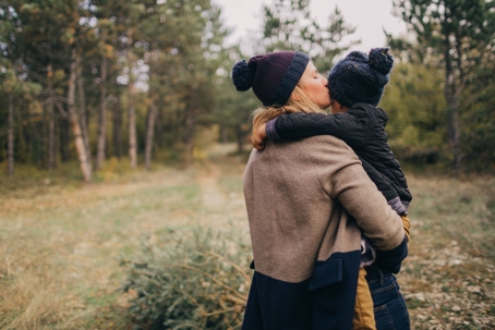 mom holding child in winter cold outside