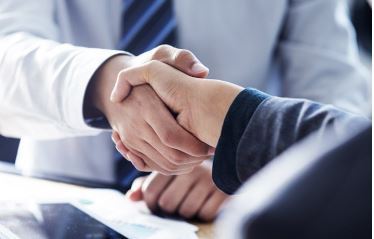 Two men in suits shaking hands