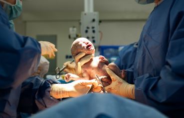 Doctor holding newborn baby
