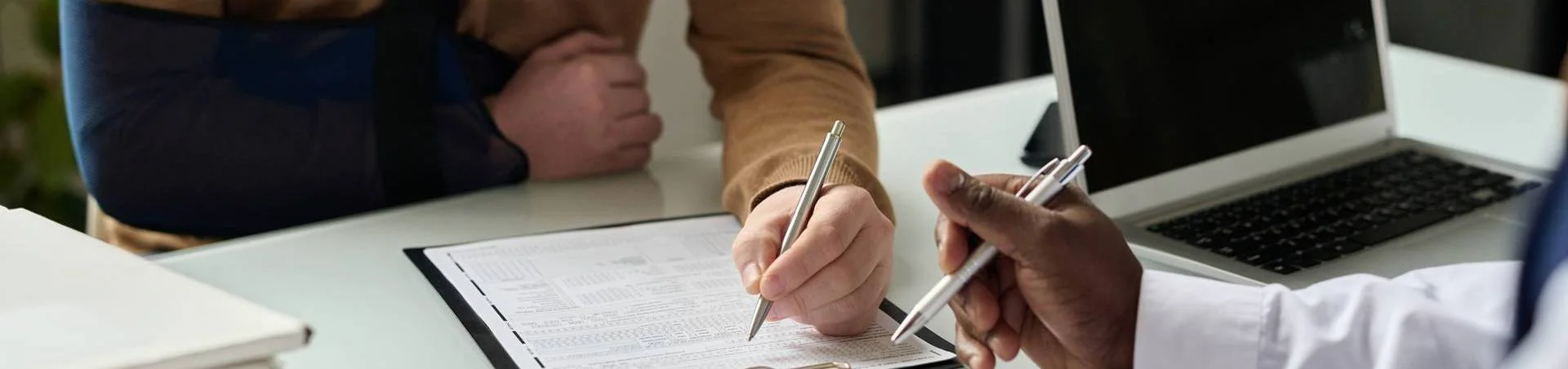 Injured person wearing an arm sling during a premises liability consultation